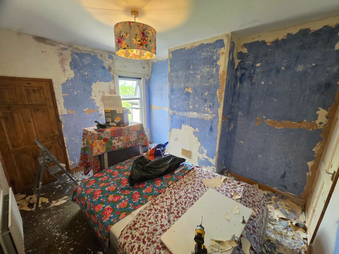 Bedroom mid-strip with wallpaper removed before redecoration