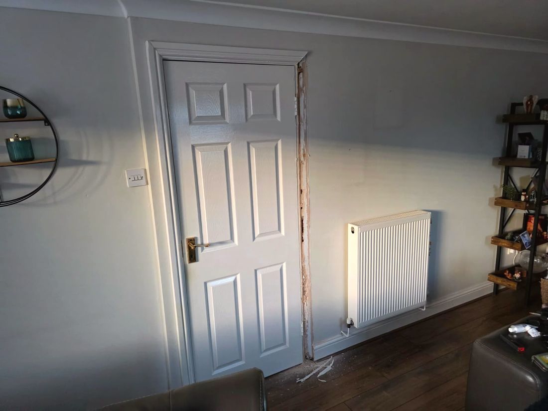 Plain living room wall with a door before the feature wall was installed