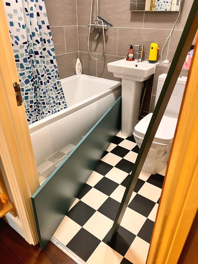 New black and white checkered bathroom floor and bath panel