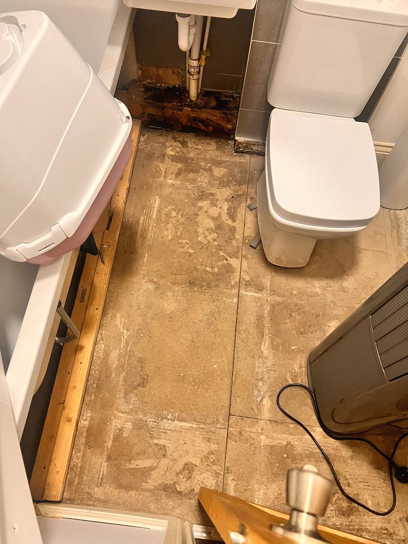 Bathroom floor stripped back before new flooring