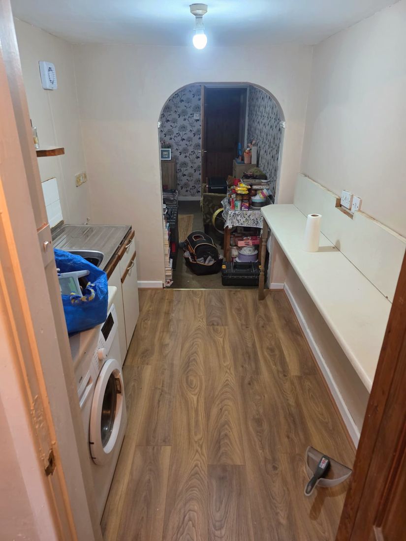 Refreshed kitchen with freshly painted walls and new wood-effect flooring