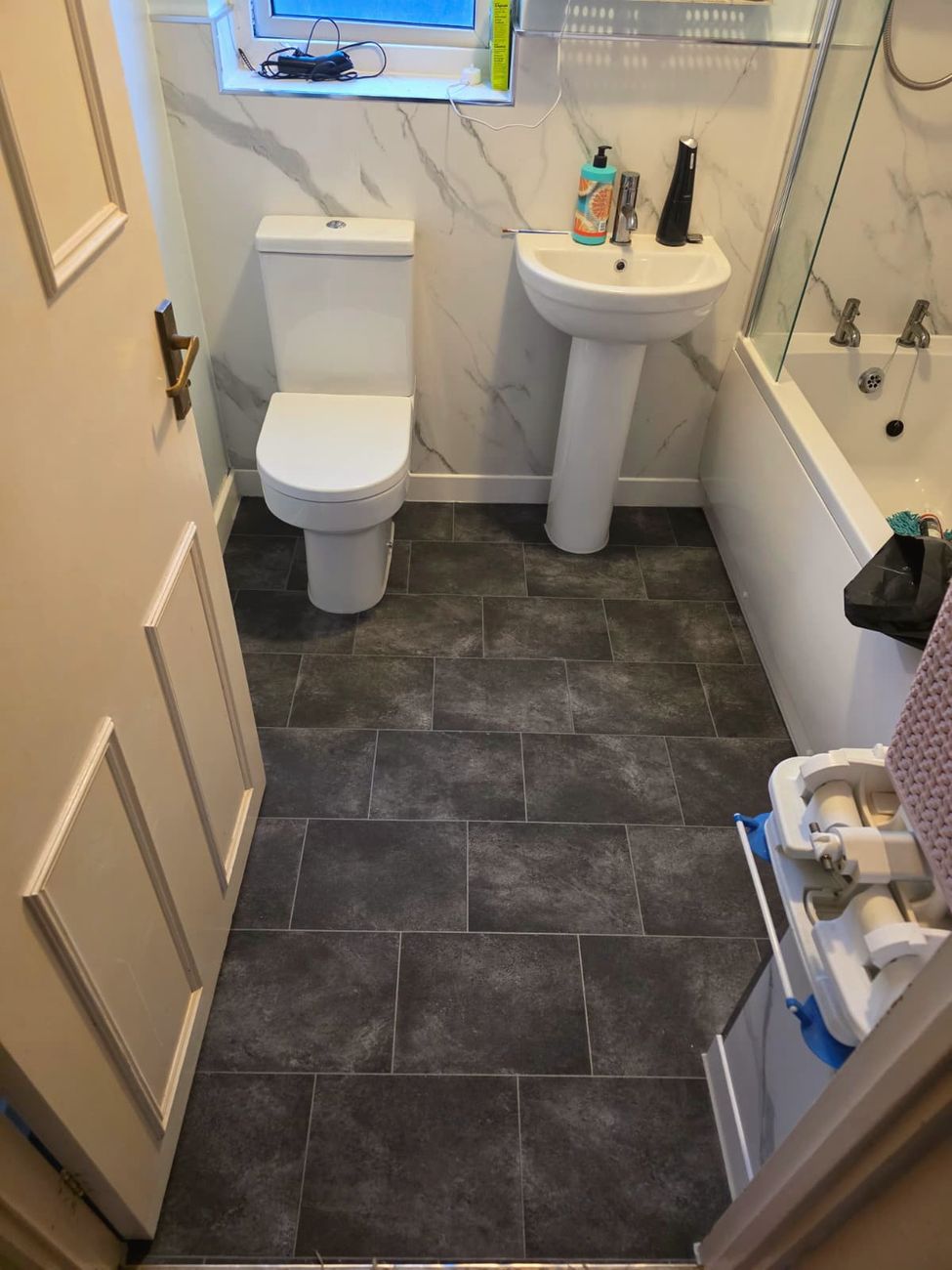 Finished marble-effect bathroom with new floor tiles