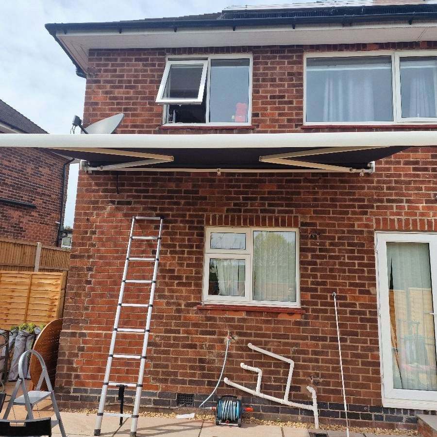 A retractable patio awning fitted to the back of a house